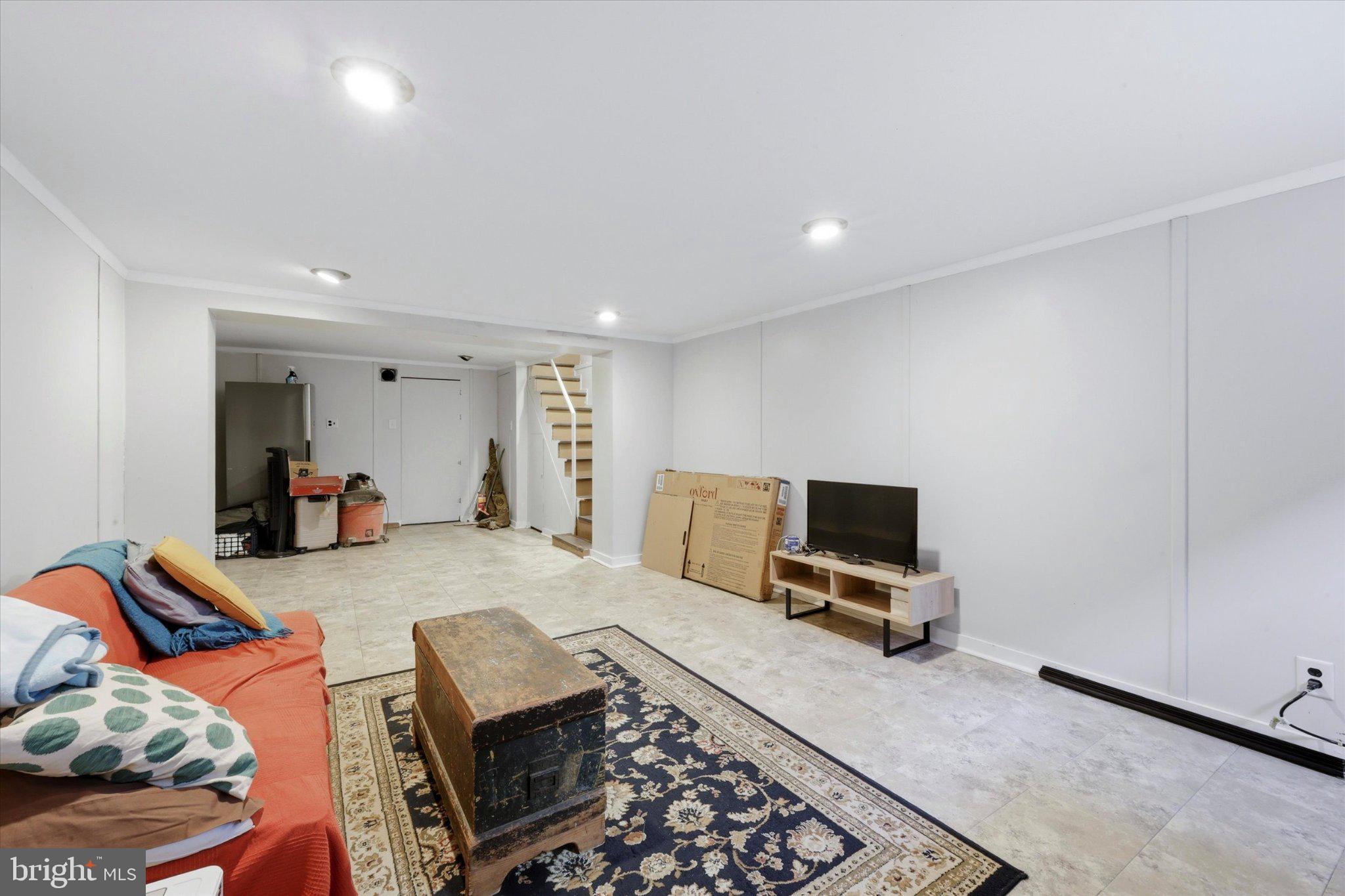 2834 Edgemont Street Philadelphia, PA 19134 - Photo 31 of 37 a living room with furniture a flat screen tv and a window