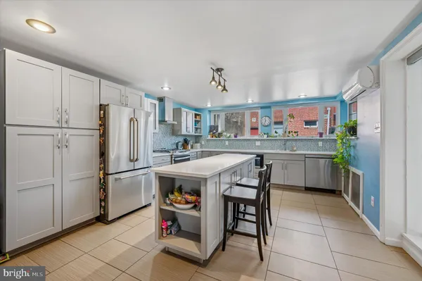 a kitchen with refrigerator cabinets and wooden floor