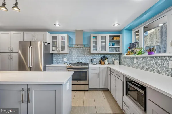 a kitchen with a sink stove and refrigerator