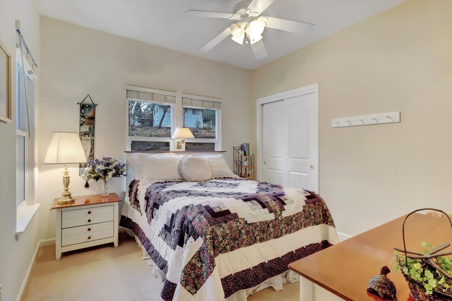 17036 Alice Way Grass Valley, CA 95949 - Photo 26 of 58 a bedroom with a bed and a chandelier