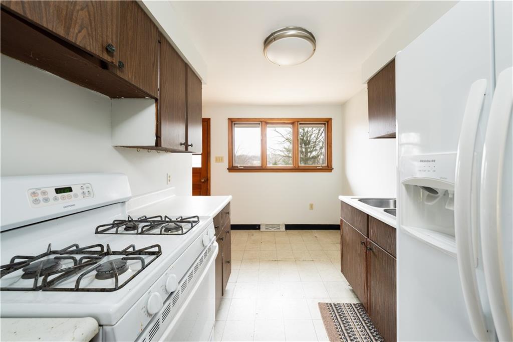5188 Richland Road Gibsonia, PA 15044 - Photo 9 of 27 Kitchen includes gas stove and refrigerator.