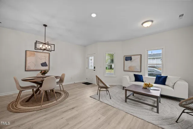 a living room with furniture a rug and a chandelier