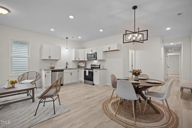 a view of a dining room with furniture kitchen and wooden floor