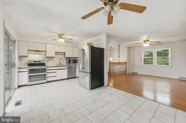 a kitchen with stainless steel appliances a refrigerator and a stove top oven