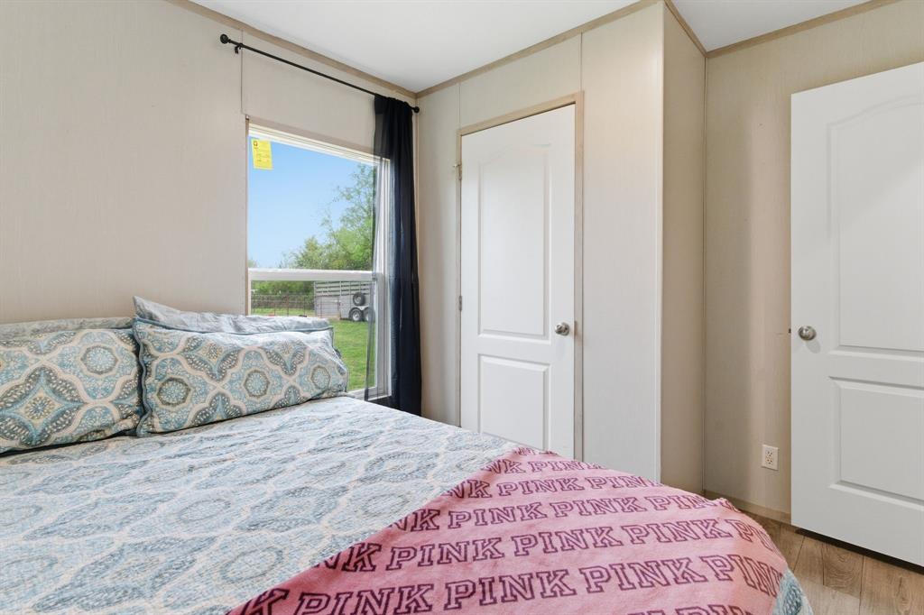 8792 Highway 67 Saltillo, TX 75478 - Photo 36 of 40 a bedroom with a large bed and a window