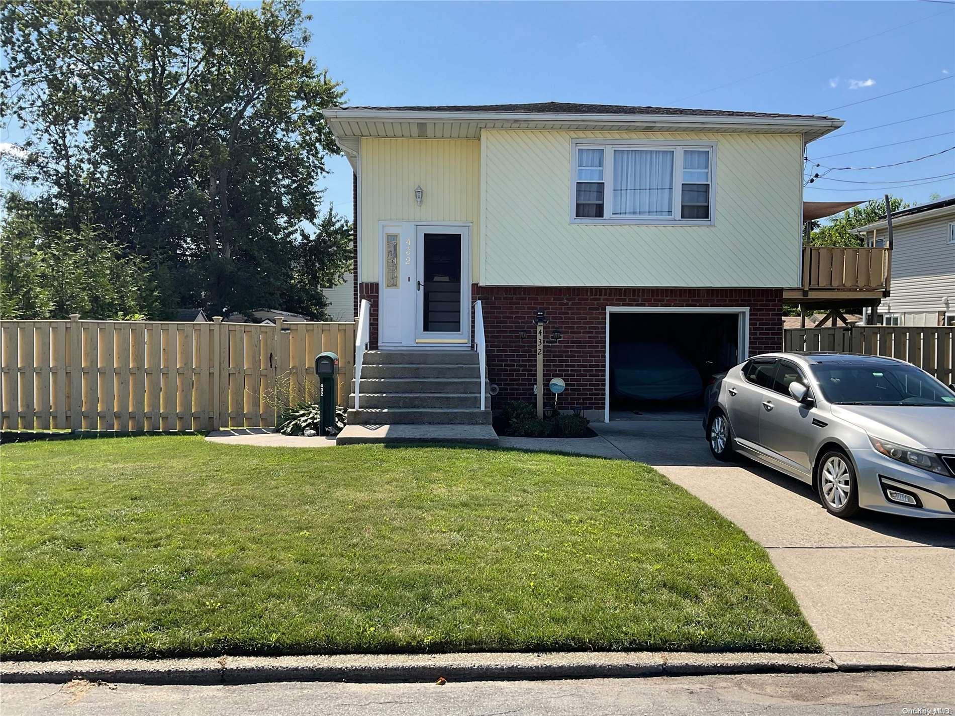 432 Heathcote Road Lindenhurst, NY 11757 - Photo 1 of 1 a view of a house with backyard and a tree