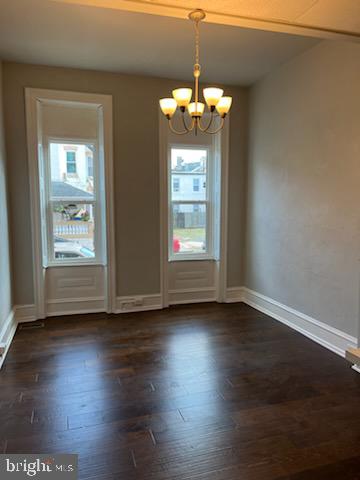 311 Elm Street, Unit 1 Reading, PA 19601 - Photo 3 of 20 an empty room with wooden floor chandelier and windows