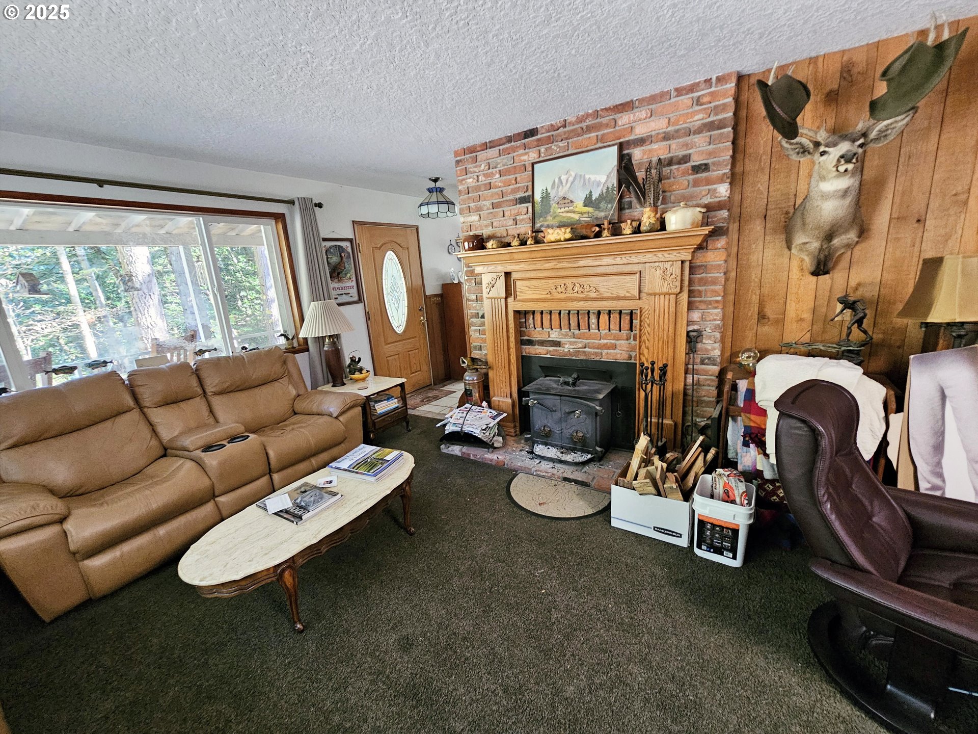 3463 Briarwood Road Umpqua, OR 97486 - Photo 2 of 29 a living room with furniture a fireplace and a large window