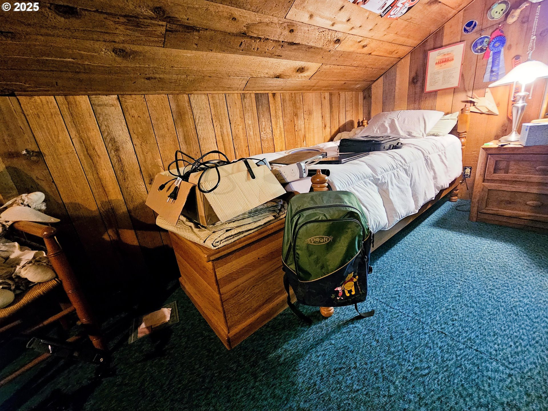 3463 Briarwood Road Umpqua, OR 97486 - Photo 28 of 29 a utility room with a bed and a chandelier