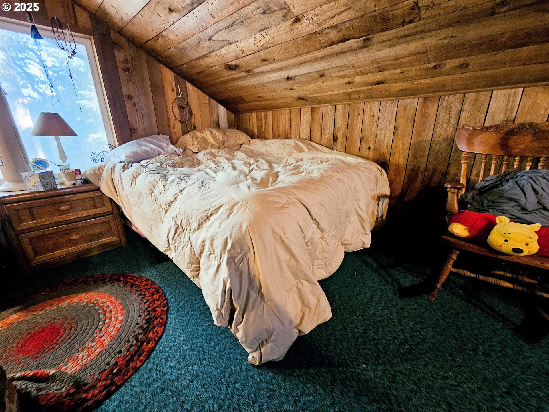 3463 Briarwood Road Umpqua, OR 97486 - Photo 9 of 29 a bed sitting in a bedroom next to a window
