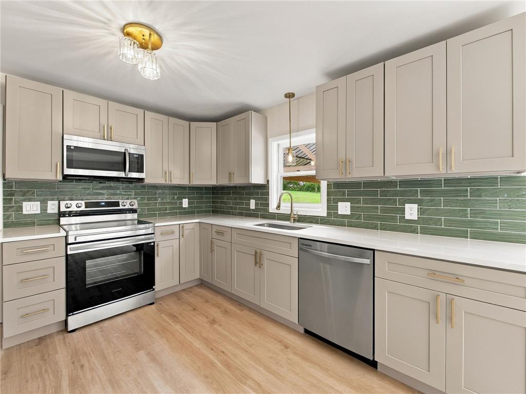 90 Gun Club Road Palmerton, PA 18071 - Photo 29 of 58 Modern cabinetry and sleek stone countertops define this beautifully updated kitchen workspace.