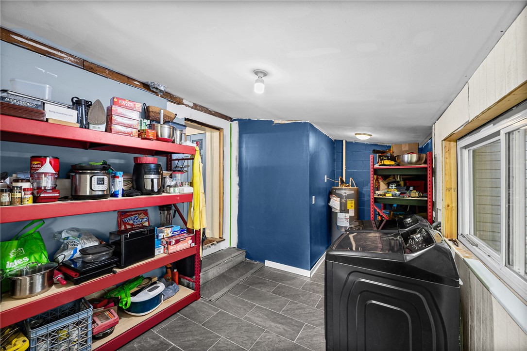 203 Muller Road Walhalla, SC 29691 - Photo 20 of 34 Durable tile flooring and practical storage shelving define this functional utility space. Just needs a little more finishing to get it all done.