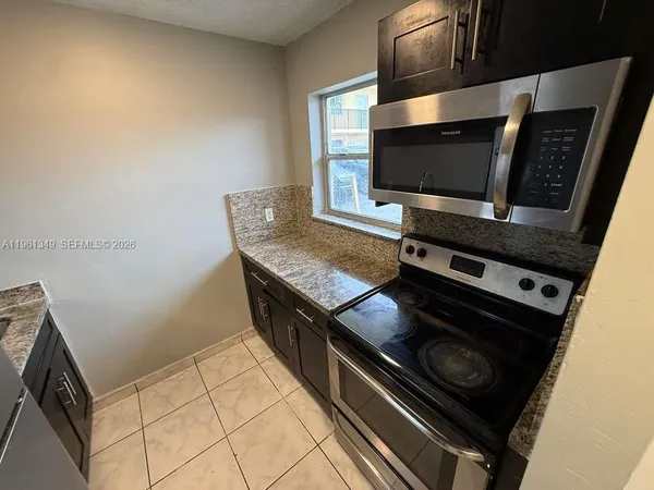 a kitchen with a stove and a microwave
