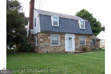 8405 Liberty Road Windsor Mill, MD 21244 - Photo 1 of 3 a front view of a house with a garden