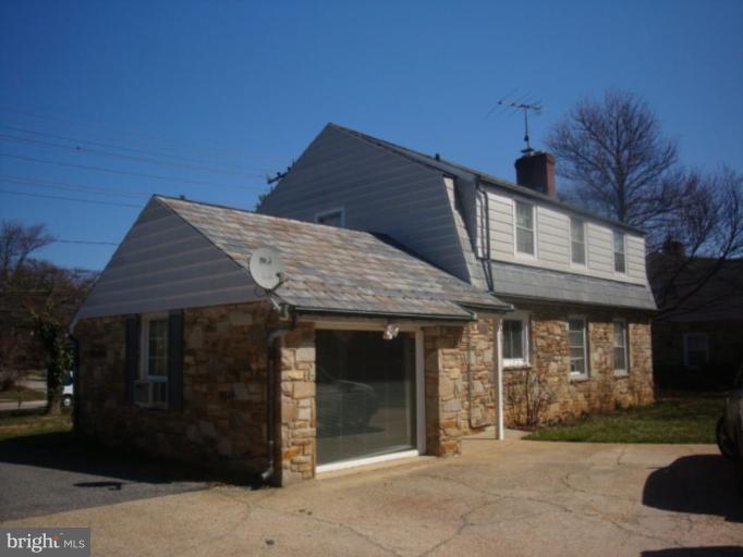 8405 Liberty Road Windsor Mill, MD 21244 - Photo 2 of 3 a front view of a house with garden