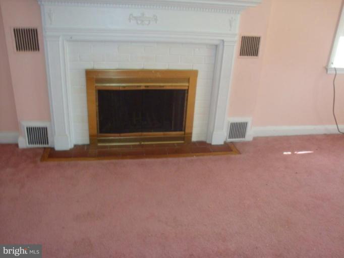 8405 Liberty Road Windsor Mill, MD 21244 - Photo 3 of 3 a view of empty room with a fireplace