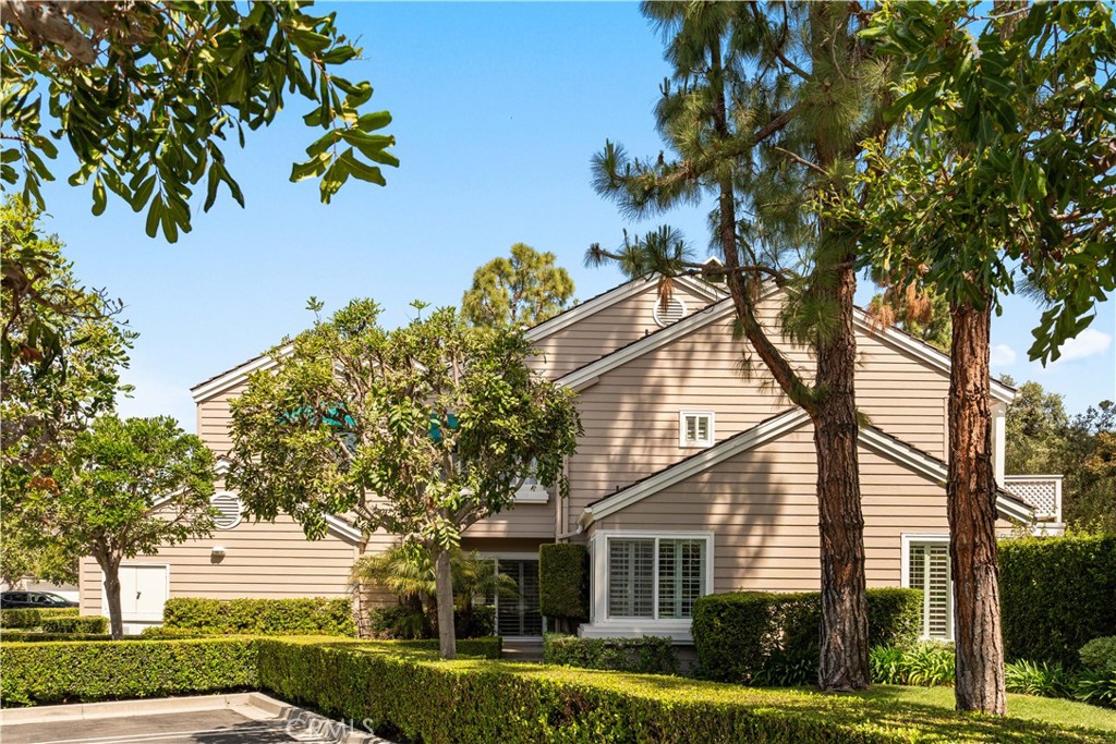 26 Lakefront, Unit 76 Irvine, CA 92604 - Photo 1 of 3 front view of a house with a garden