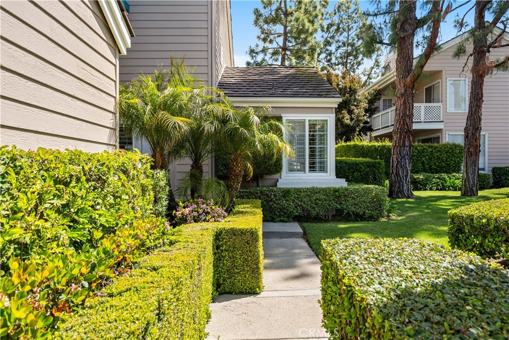 26 Lakefront, Unit 76 Irvine, CA 92604 - Photo 2 of 3 a front view of a house with garden