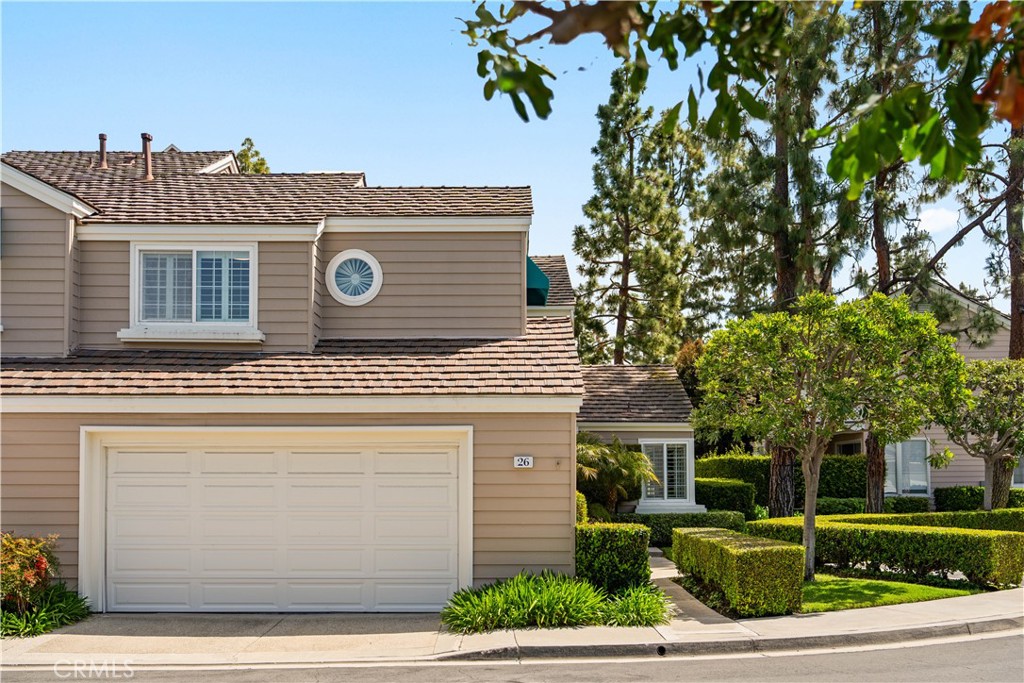 26 Lakefront, Unit 76 Irvine, CA 92604 - Photo 3 of 3 a front view of a house with garden