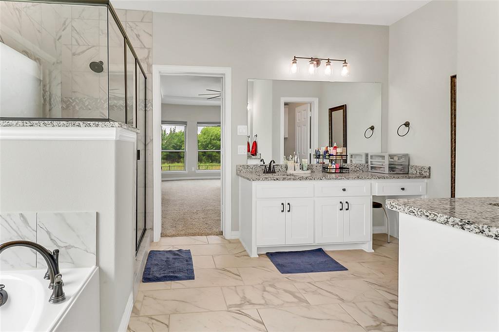 3425 Cotton Mill Road Celina, TX 75009 - Photo 15 of 40 a spacious bathroom with a granite countertop sink and a mirror