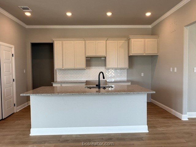 6428 Raleigh Loop College Station, TX 77845 - Photo 6 of 20 a view of a kitchen with kitchen island a sink wooden floor and a refrigerator
