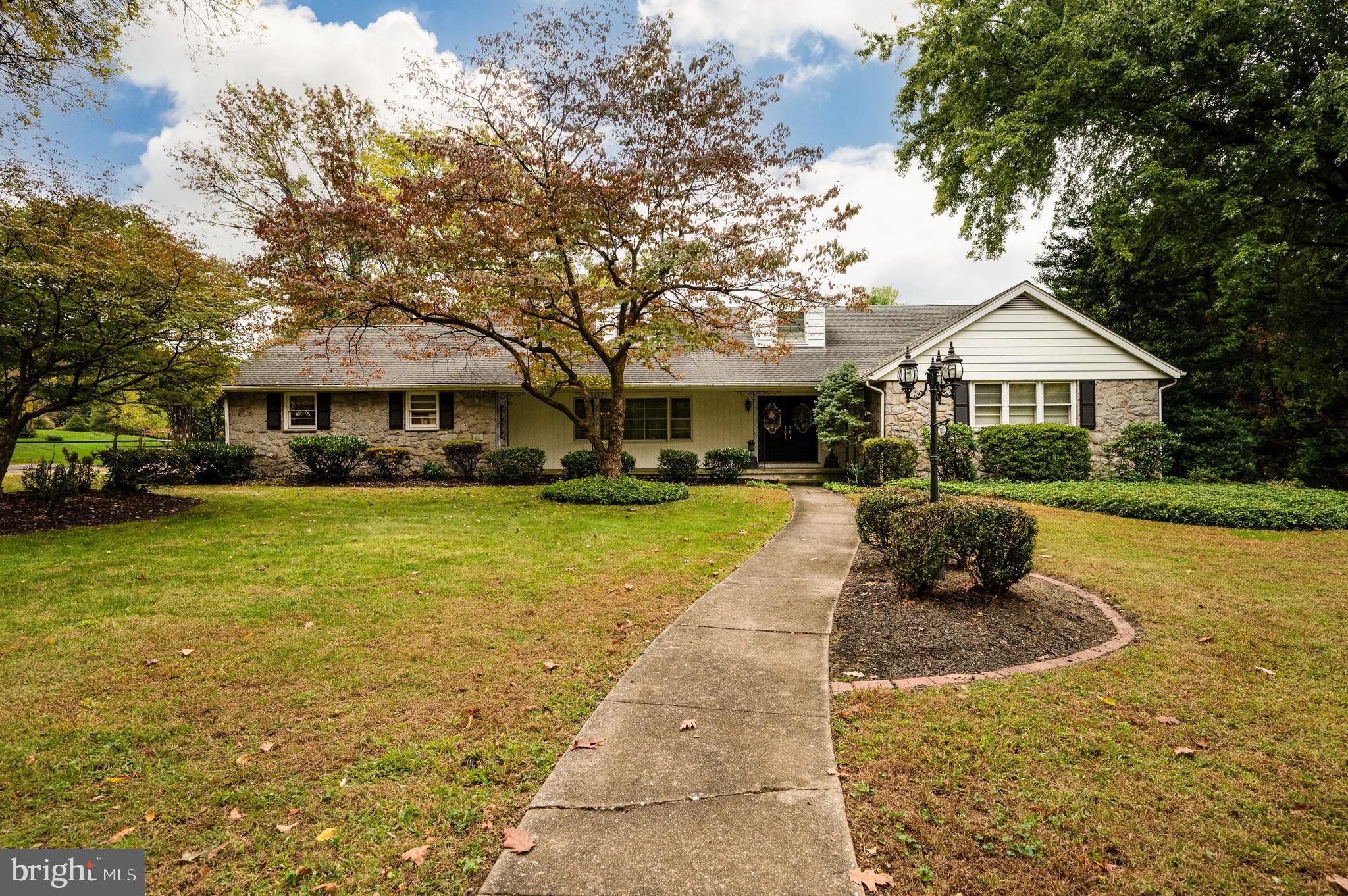 1202 Old Mill Road Wyomissing, PA 19610 - Photo 1 of 58 a front view of a house with a yard