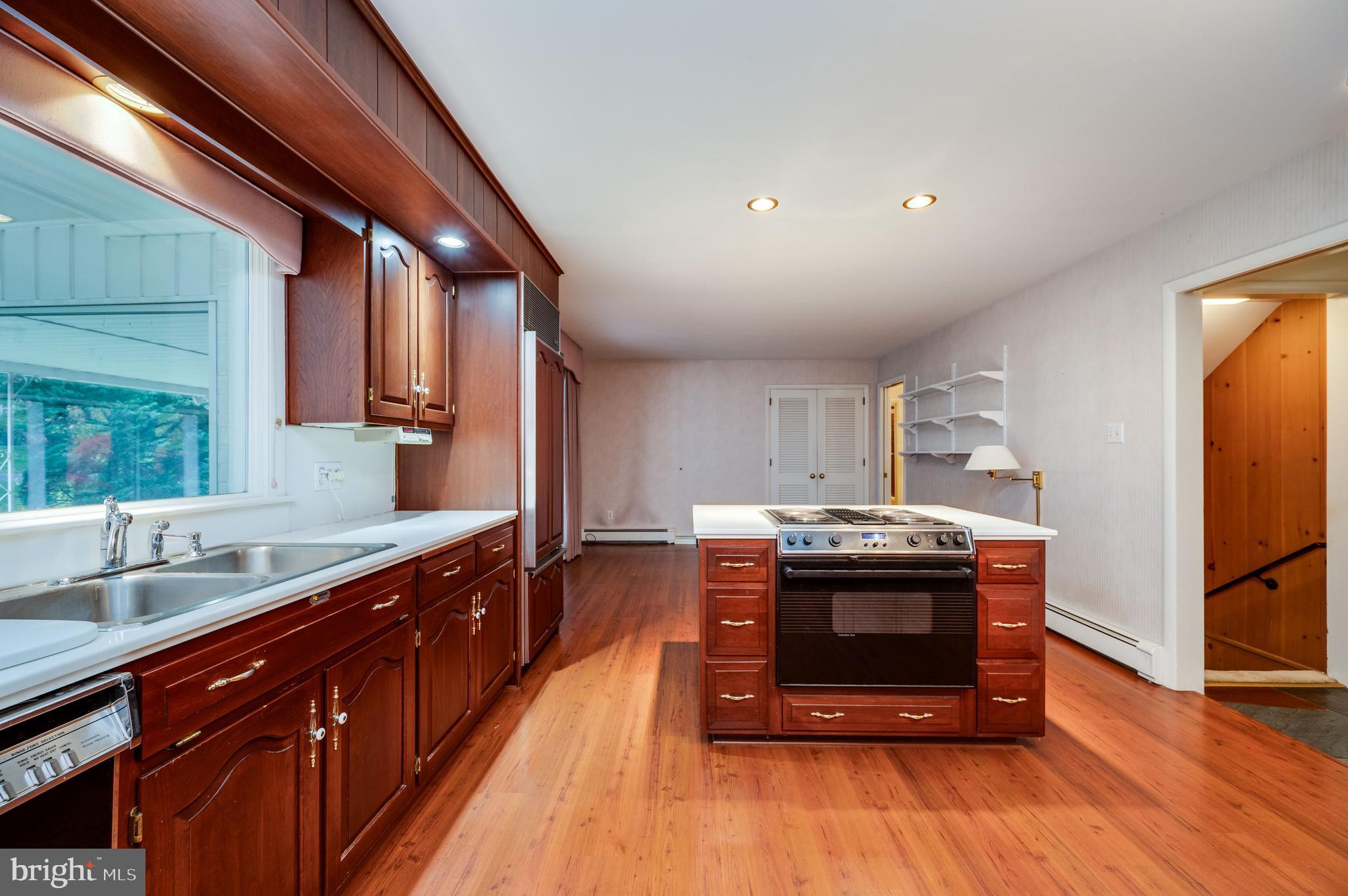 1202 Old Mill Road Wyomissing, PA 19610 - Photo 11 of 58 a kitchen with stainless steel appliances granite countertop a stove and a sink