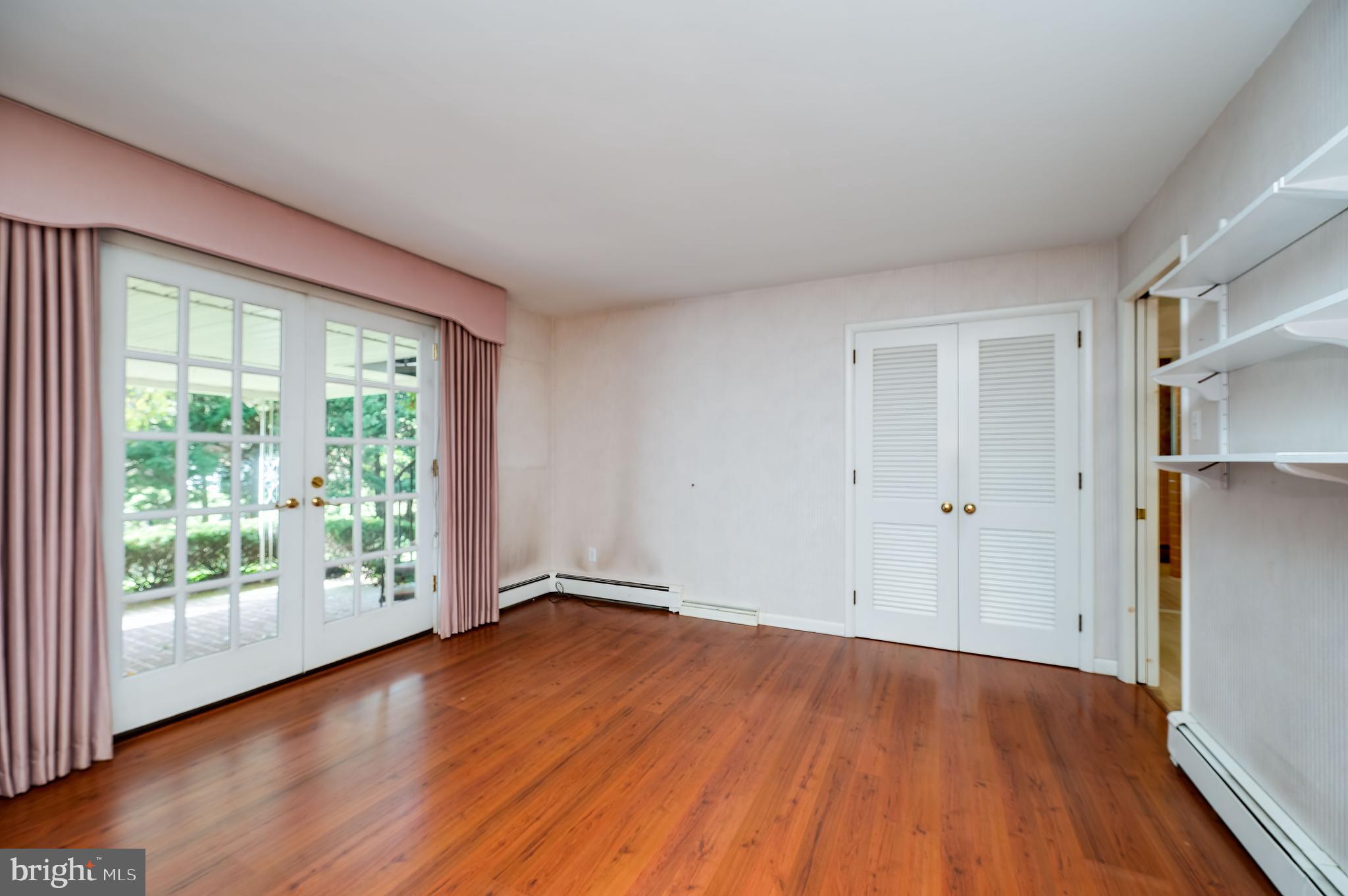 1202 Old Mill Road Wyomissing, PA 19610 - Photo 14 of 58 a view of an empty room with wooden floor and a window