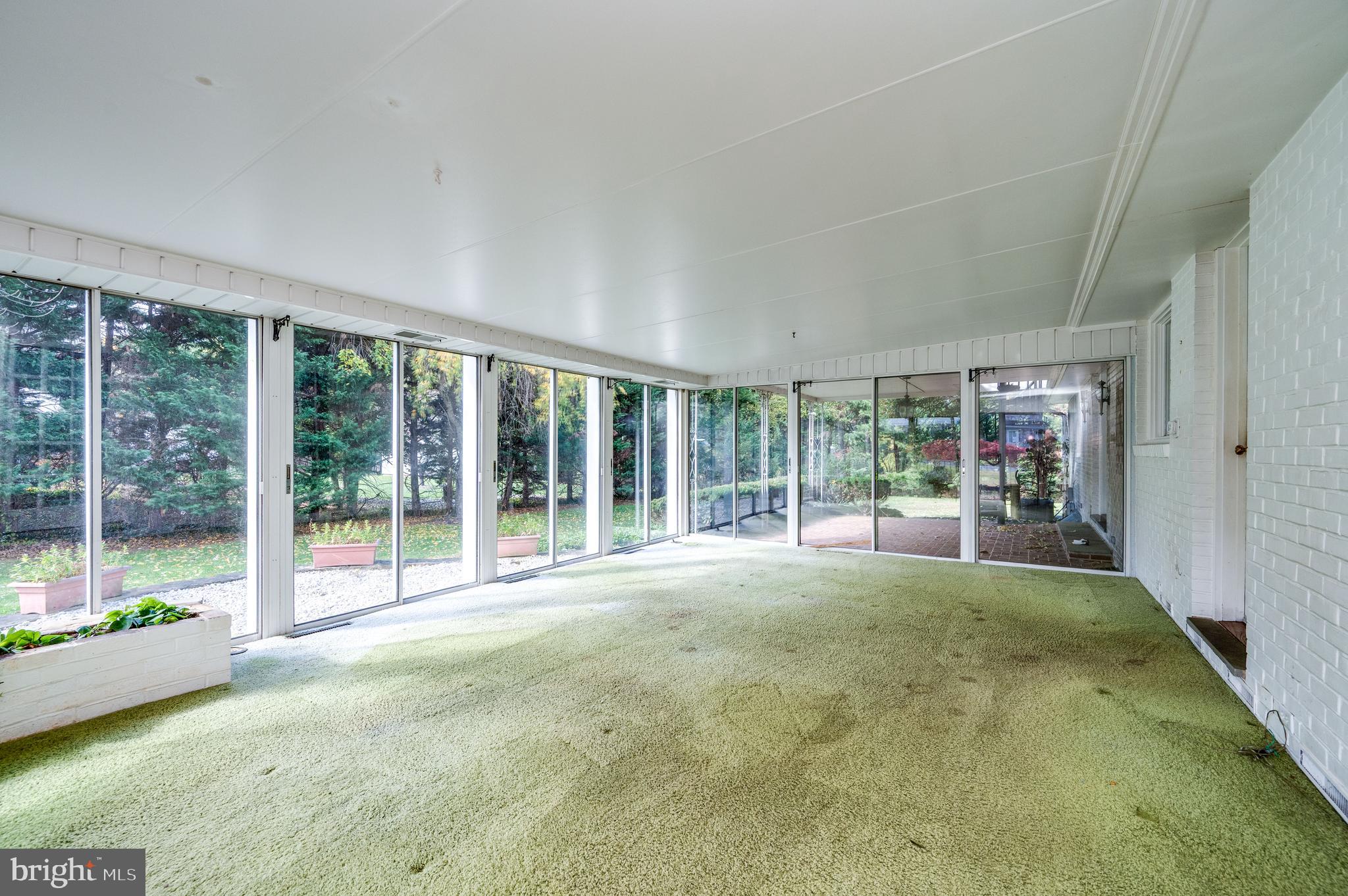 1202 Old Mill Road Wyomissing, PA 19610 - Photo 19 of 58 a swimming pool with large glass windows and table