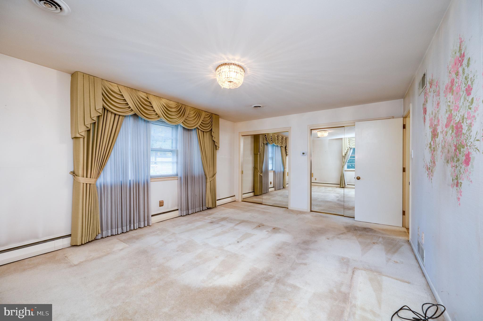 1202 Old Mill Road Wyomissing, PA 19610 - Photo 22 of 58 a view of a livingroom with wooden floor and a bathroom