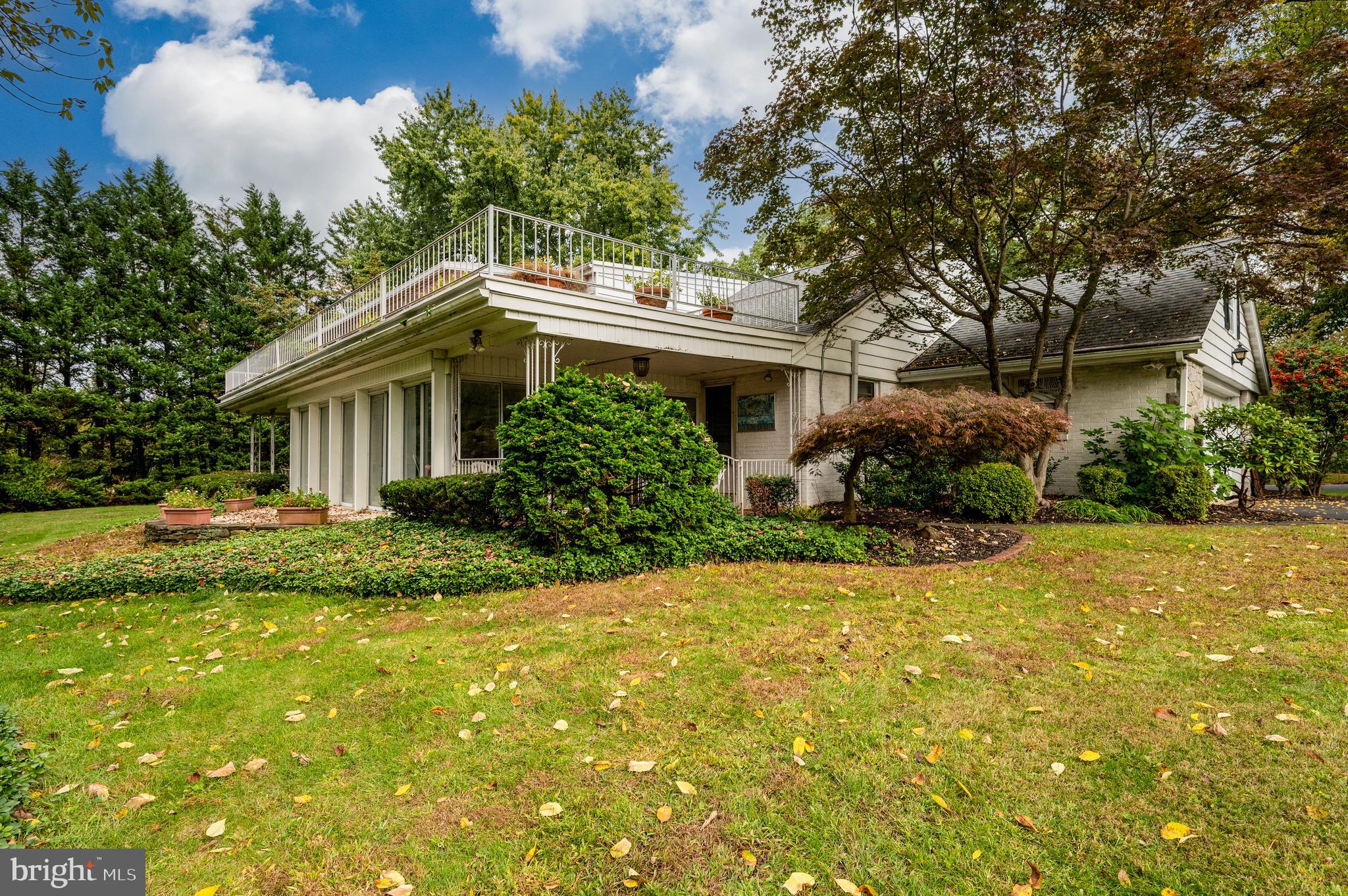 1202 Old Mill Road Wyomissing, PA 19610 - Photo 50 of 58 a front view of a house with a yard and trees