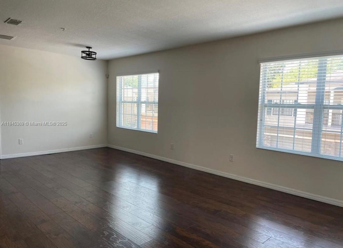 3732 Seneca Orlando, FL 32808 - Photo 2 of 8 an empty room with wooden floor and windows