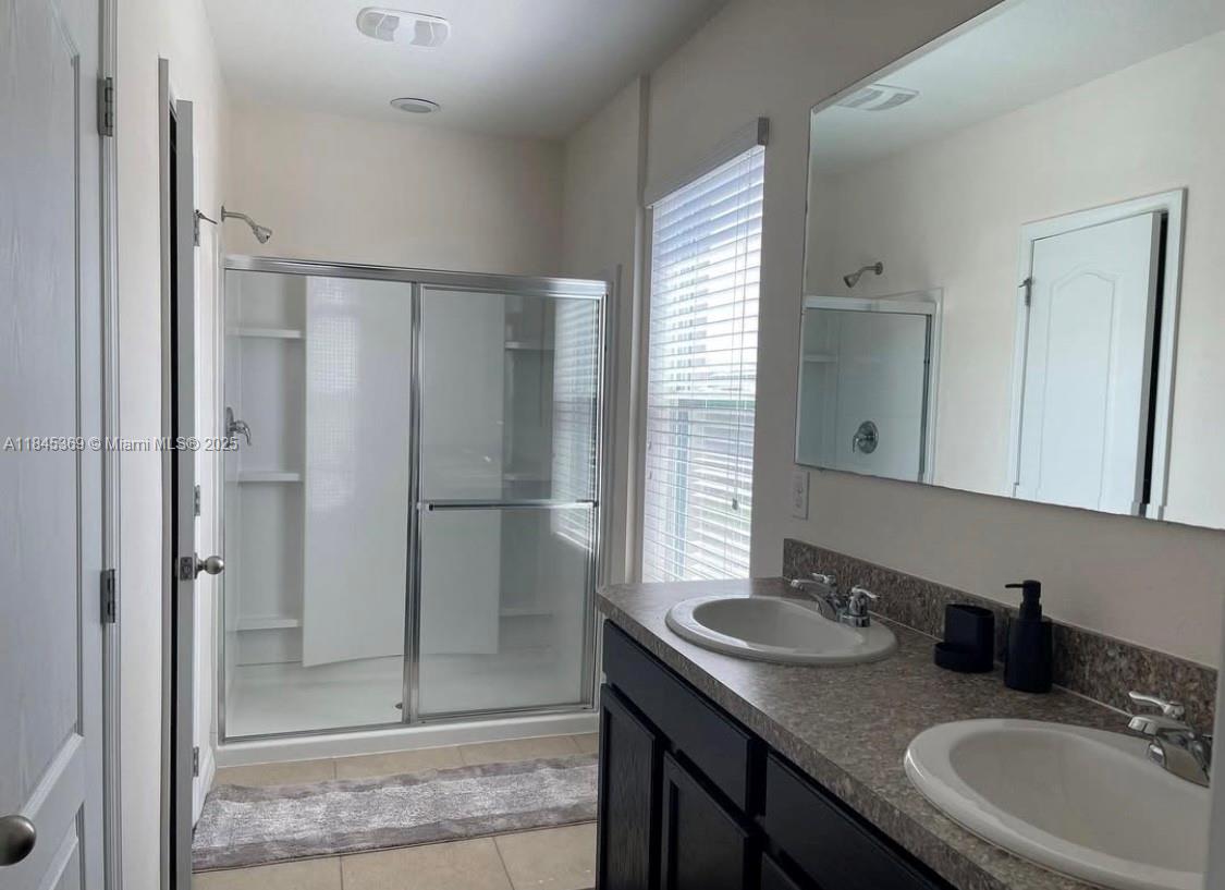 3732 Seneca Orlando, FL 32808 - Photo 5 of 8 a bathroom with a granite countertop sink and a mirror