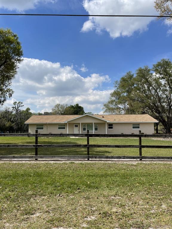 a view of a big yard with a bench