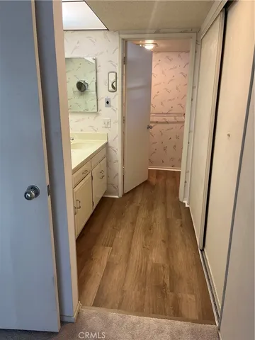 a bathroom with a sink and glass door shower