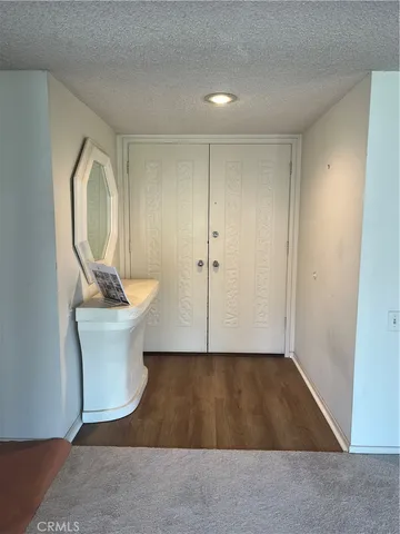 a view of a room with wooden floor and sink