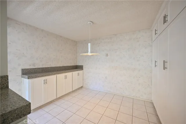 a view of a kitchen with white cabinets