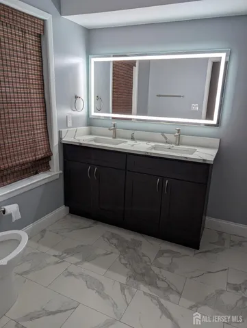 a bathroom with a sink vanity and a mirror