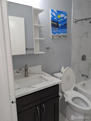 a bathroom with a sink vanity and toilet