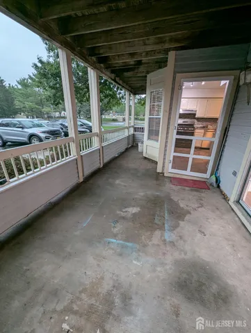 a view of a porch with wooden floor and roof