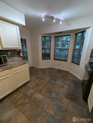 a bathroom with a sink mirror and window
