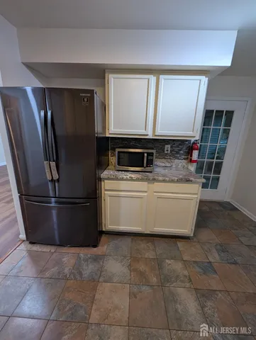 a view of kitchen with stainless steel appliances granite countertop a stove a refrigerator and a sink