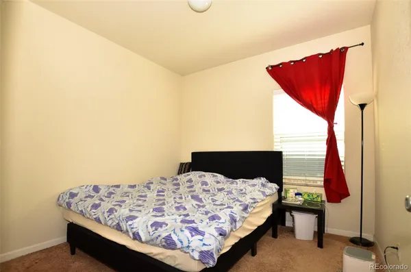 a bedroom with a bed and window