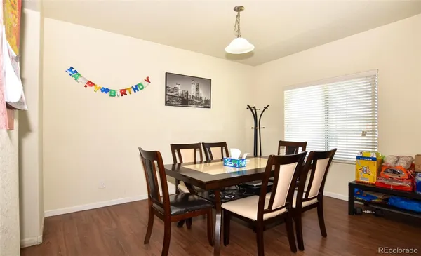 a dining room with furniture and wooden floor