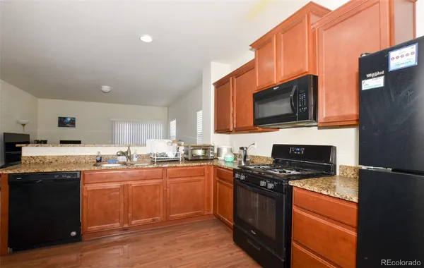 a kitchen with stainless steel appliances a stove sink microwave and cabinets