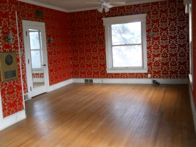 802 West 3rd Street Sterling, IL 61081 - Photo 13 of 21 an empty room with wooden floor and windows