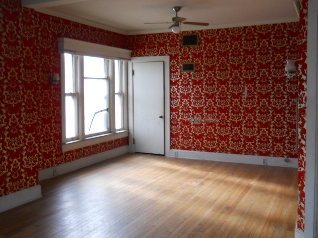 802 West 3rd Street Sterling, IL 61081 - Photo 14 of 21 an empty room with wooden floor and windows