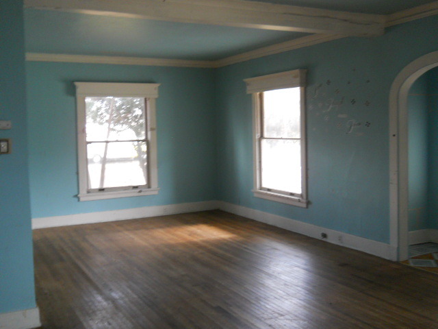 802 West 3rd Street Sterling, IL 61081 - Photo 16 of 21 an empty room with wooden floor and windows