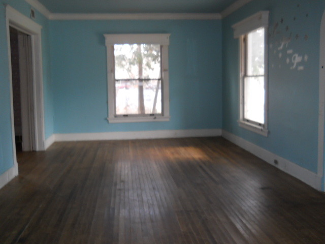 802 West 3rd Street Sterling, IL 61081 - Photo 18 of 21 an empty room with wooden floor and windows