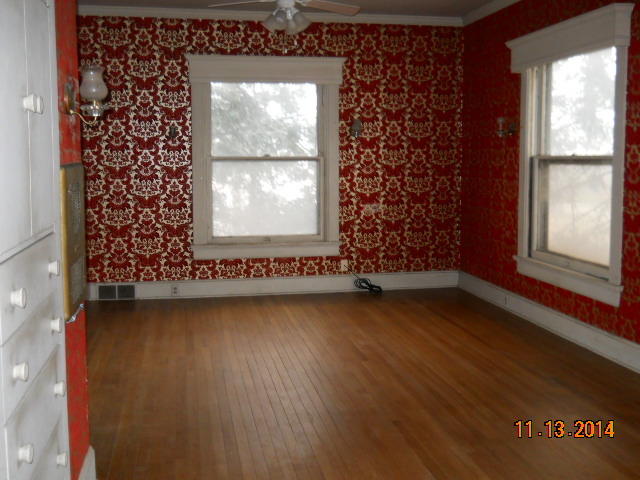 802 West 3rd Street Sterling, IL 61081 - Photo 3 of 21 an empty room with wooden floor and windows